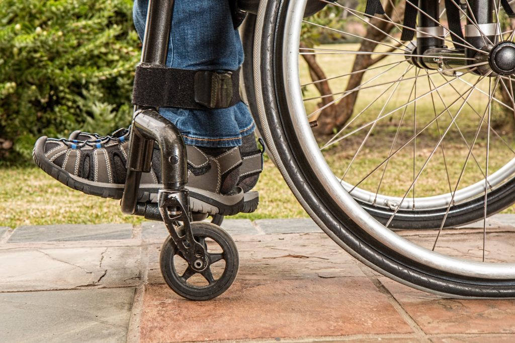 closeup of feet and wheels of wheelchair